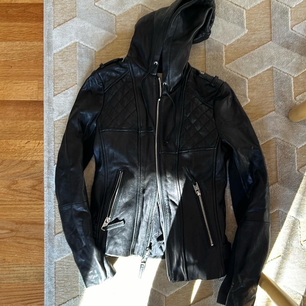 Black hooded leather jacket by Michael Kors